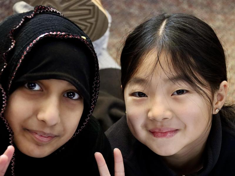 Two female students smiling at the camera.