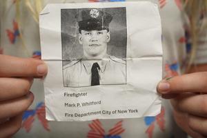 Students wore photos of firefighters who died on Sept. 11.