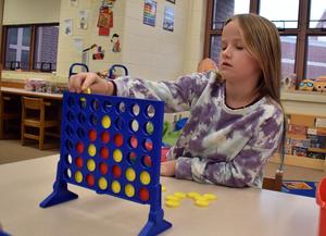 Students playing Connect Four