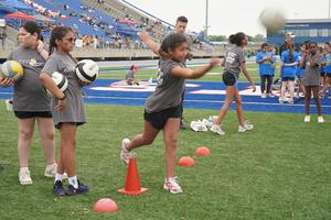 Students compete in the volleyball serve event