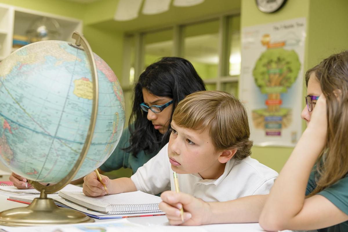 Students looking at globe