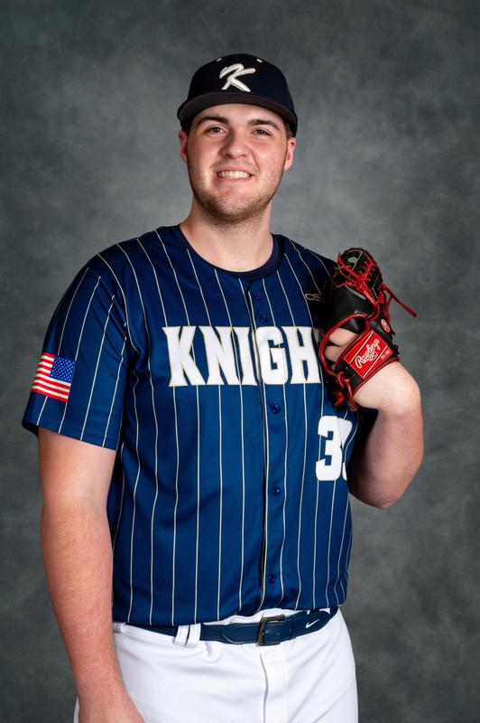 tall boy in baseball uniform holding glove