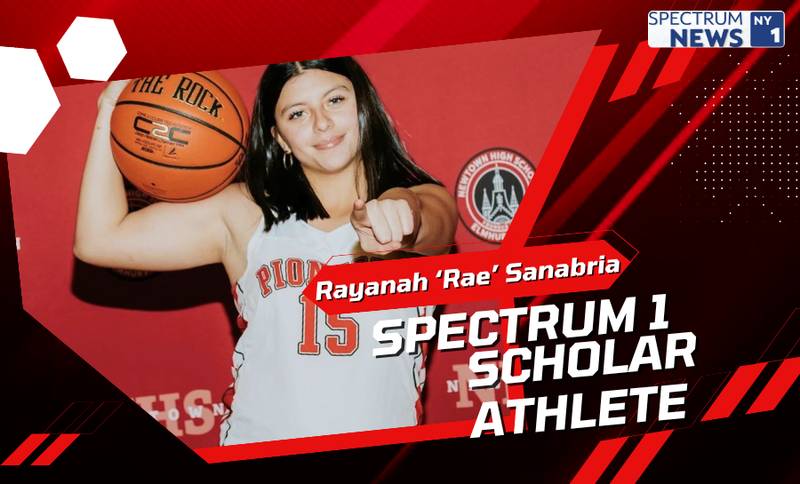 Promotional graphic featuring a basketball player in a white jersey holding an orange basketball on one shoulder and pointing toward the camera, set against a red geometric background. Visible text reads “Rayanah ‘Rae’ Sanabria,” “Spectrum 1 Scholar Athlete,” and a “Spectrum News 1” logo in the top right corner, with a high school athletics emblem partially visible in the background.