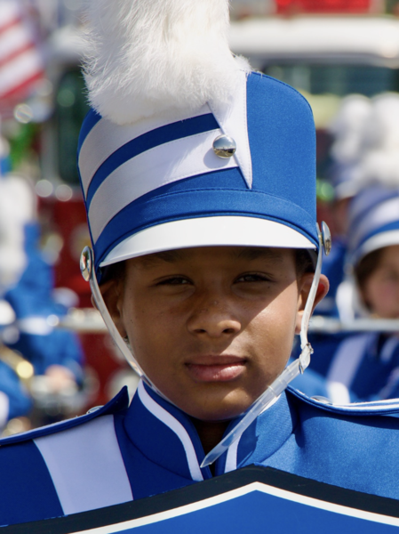 A young, Black boy wearing marching regalia