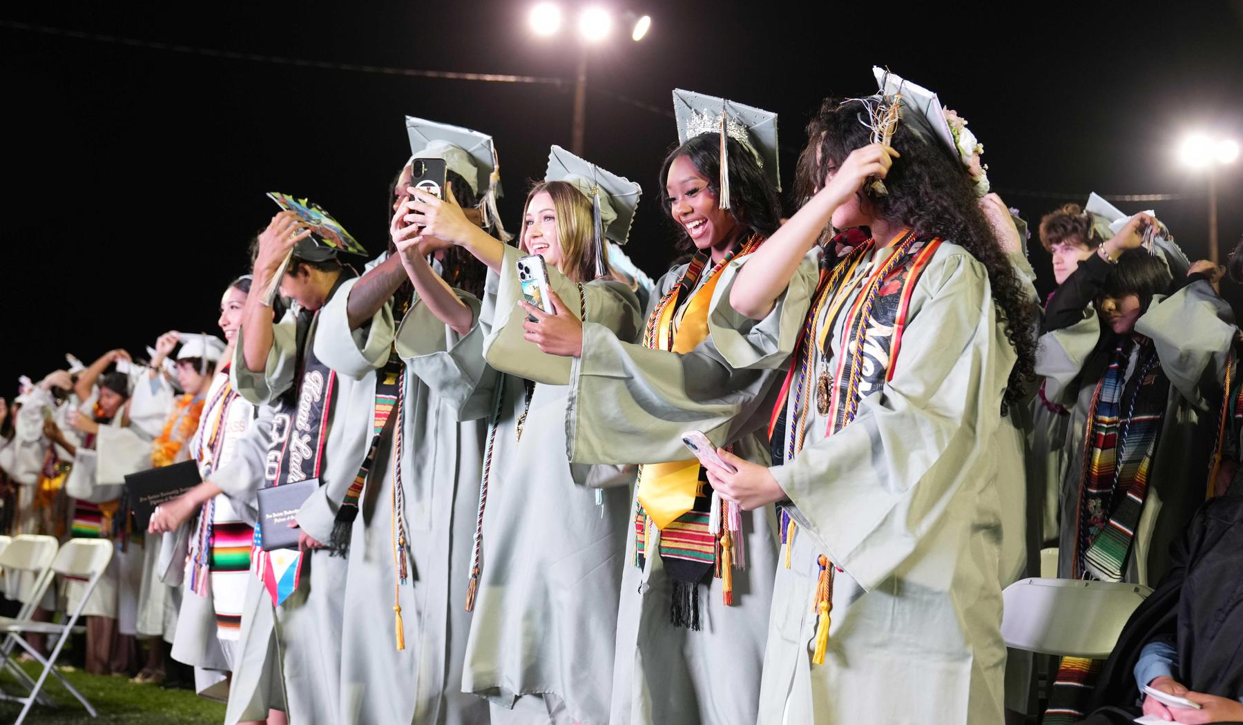SJLA Grads moving tassel during graduation ceremony