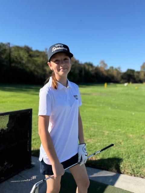 girl playing golf