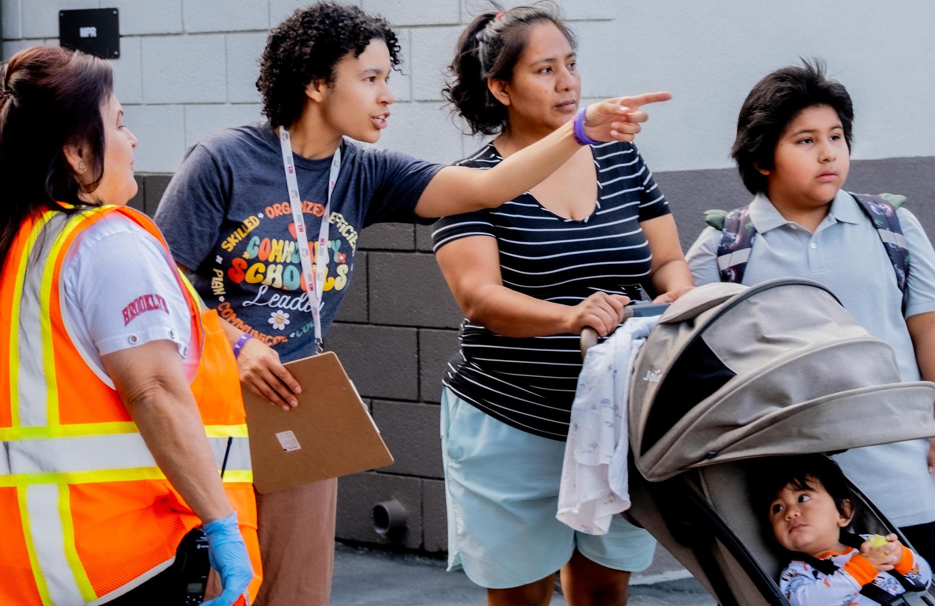staff points out where to go to a parent