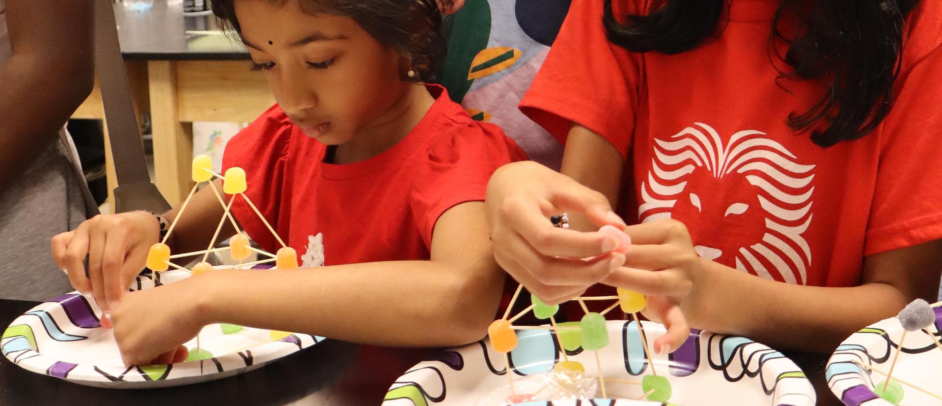 Arts and Science Fest visitors make atoms out of gum drops and toothpicks