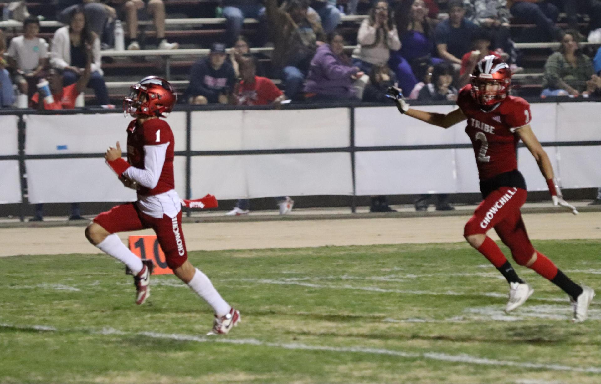 varsity football players in action against Riverdale