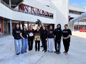 SVHS Girls Basketball players, coaches, and athletic director pose for a photo with CBS News Crew on campus.