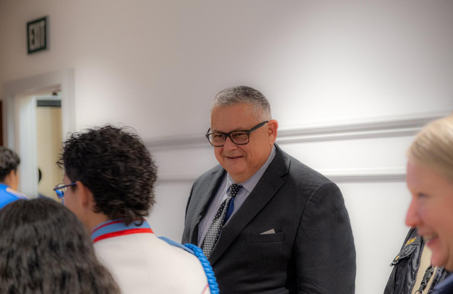 board member looking at student