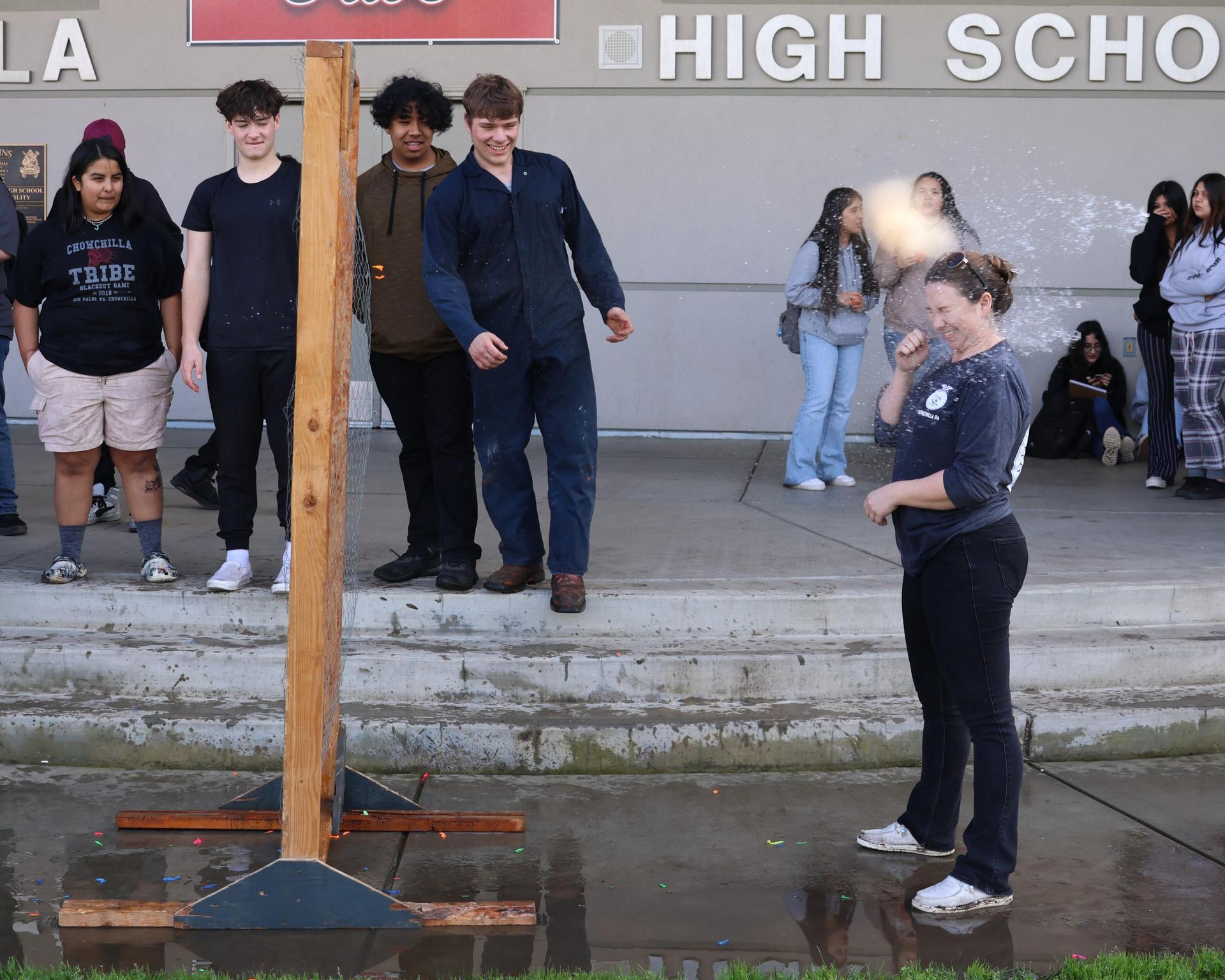 students and staff enjoying the water balloon toss