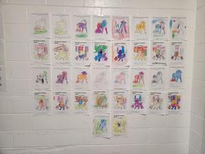 Coloring contest entries hanging on a wall.
