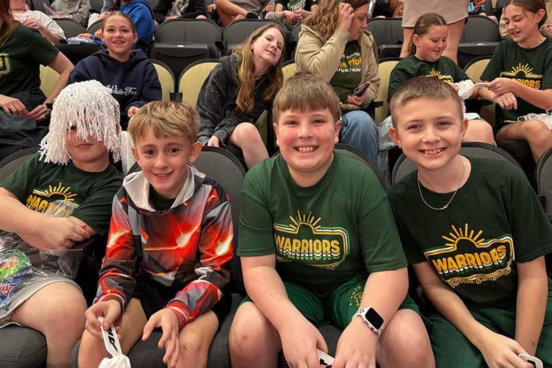 Sunrise Elementary students Makson McCloy, Kamryn Champion, Nick Caito, and Landon Baughman enjoy the game from their arena seats