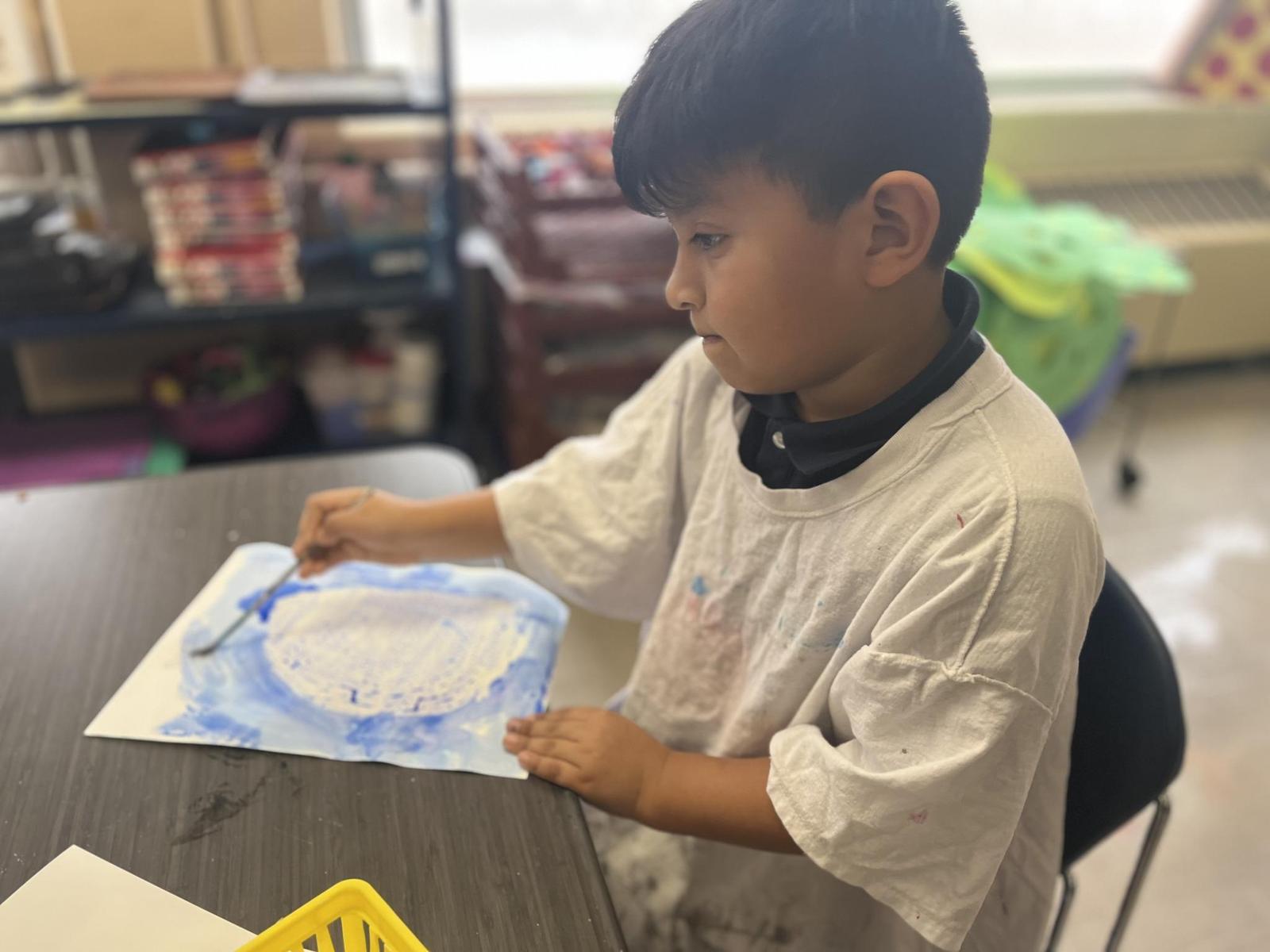 Kindergarten boy painting