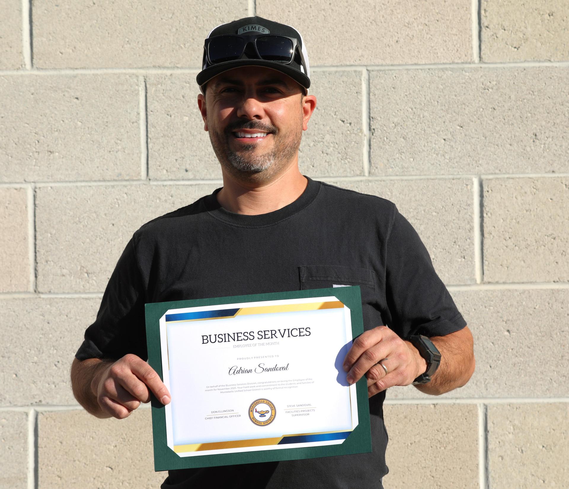 Picture of employee holding certificate
