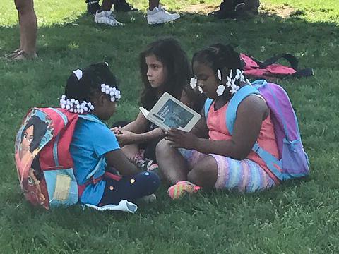 kids sitting on grass