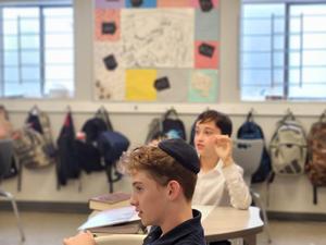 An eighth grade boy asks Rabbi Silverman a question.