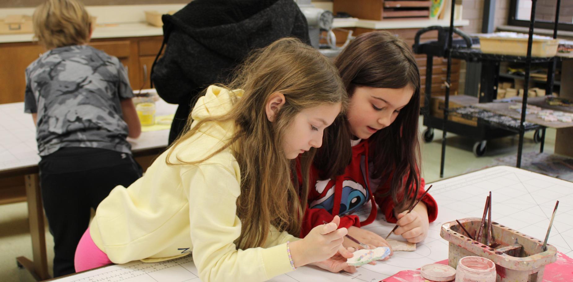 students painting ornaments