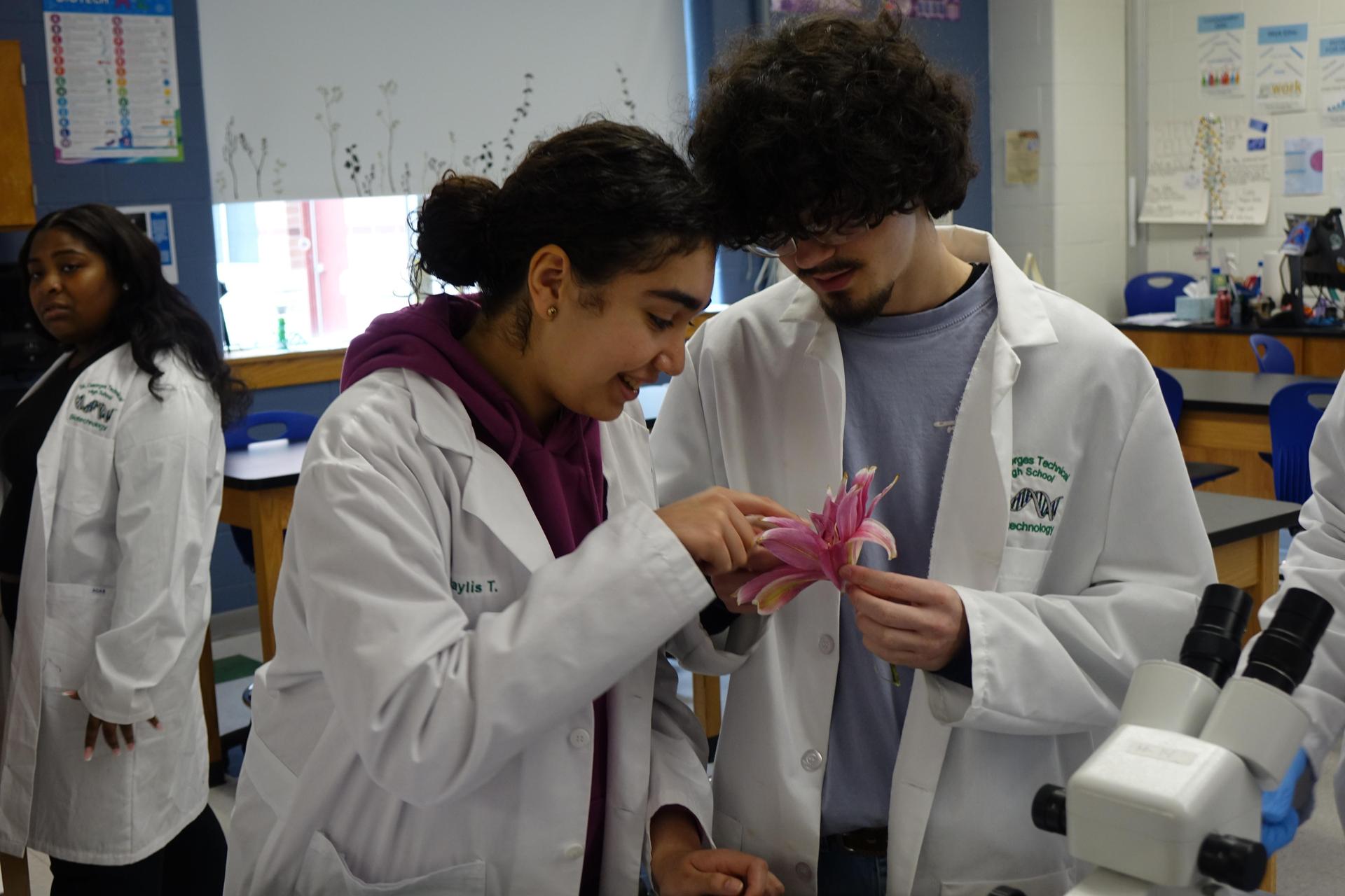 biotechnology students examining the parts of a flower