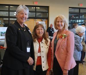 TKAA Historian, Cindy Middlebush and alum Wanita Huizenga greet Sandi (Stager) Wake.