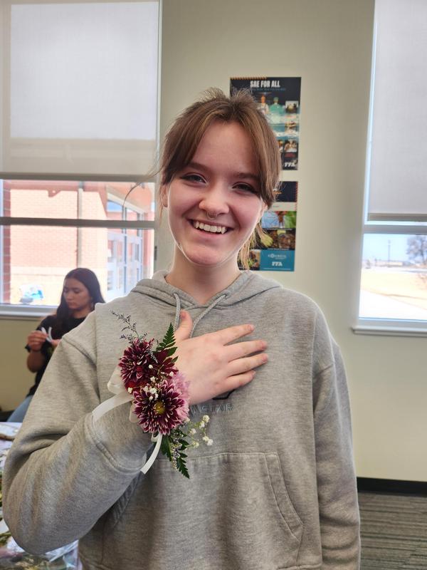 Sedya Thomas holding her hand showing off the corsage she made.