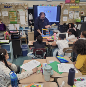 teacher and students building skyscrapers using simple materials