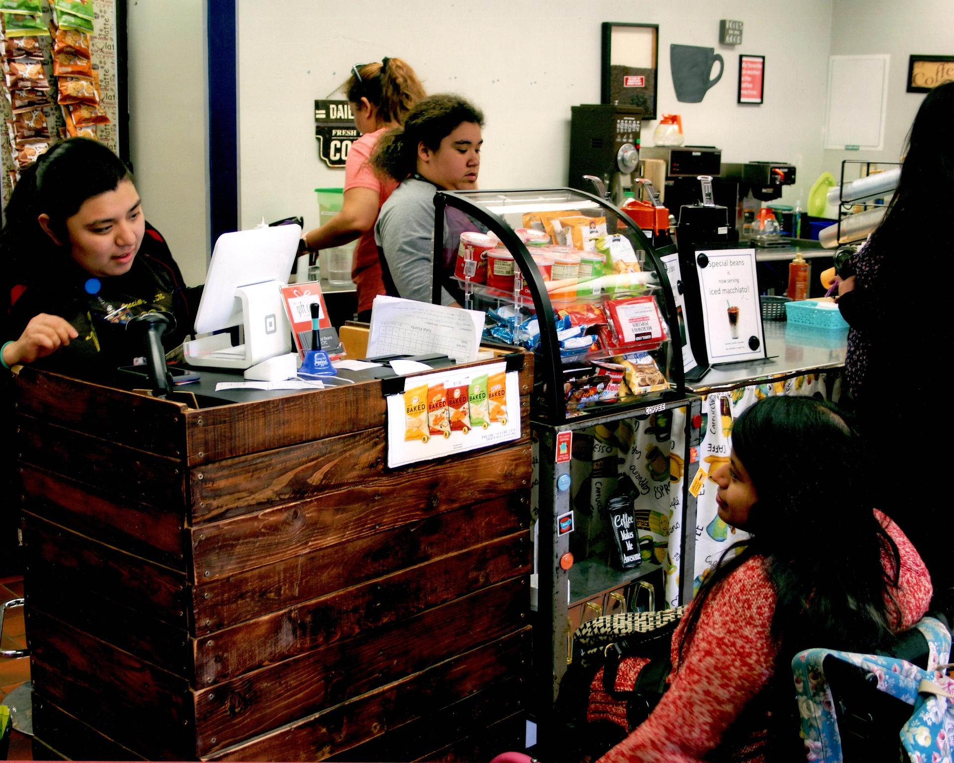 Students waiting on customers in the coffee shop