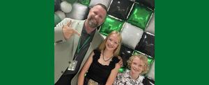 Dr. DeBoer taking picture at Picture Day with two students