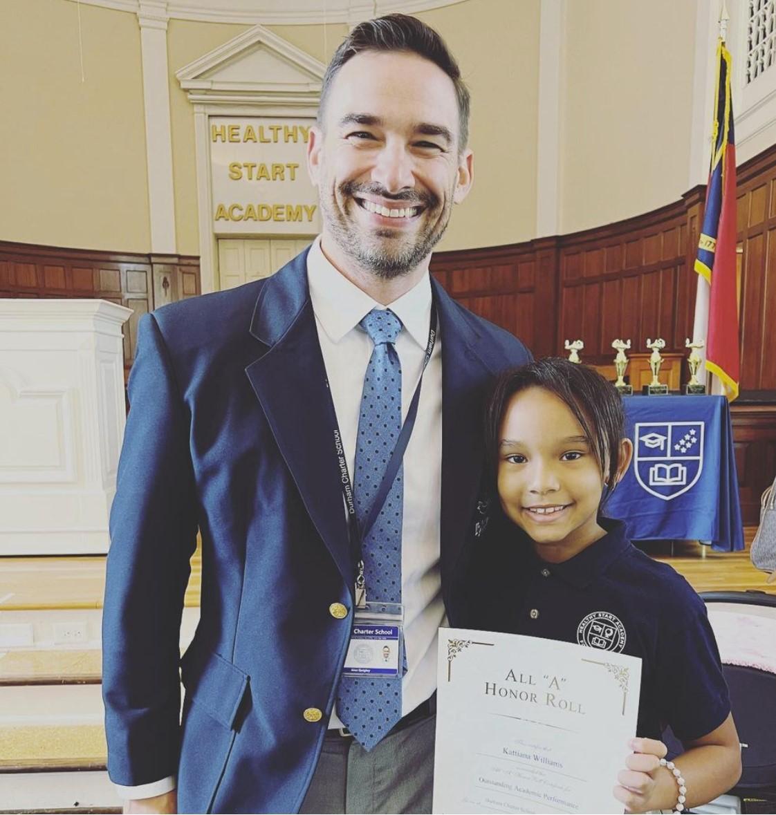 Principal Quigley gives an award