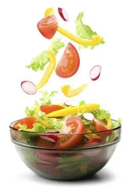 A salad falling into bowl