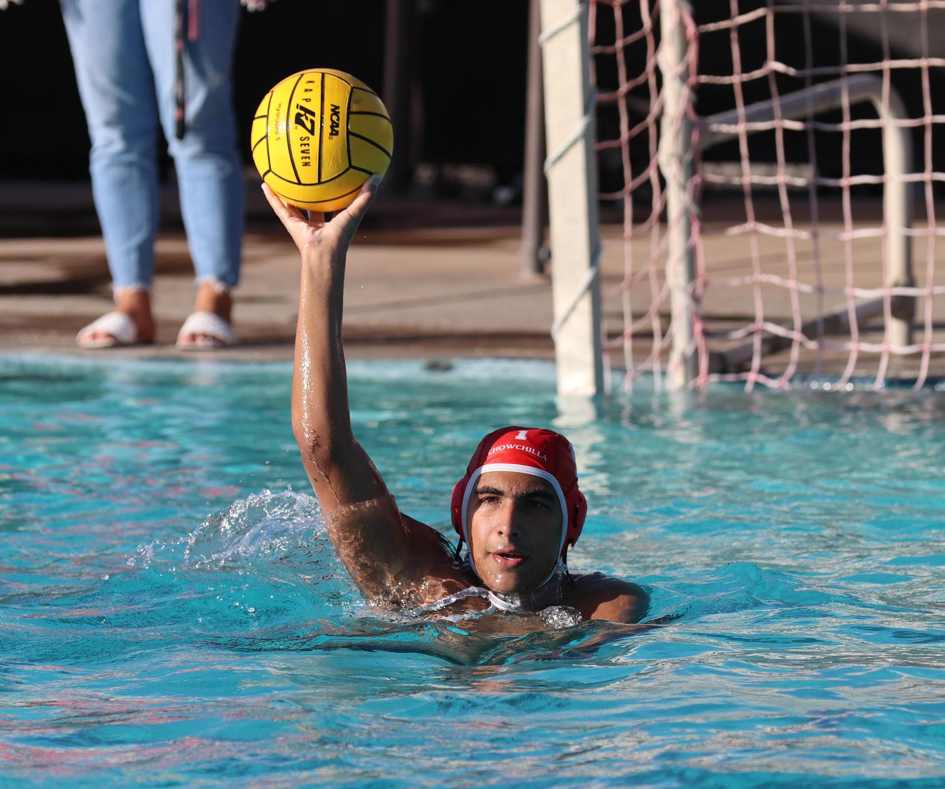 boys water polo players in action against hoover