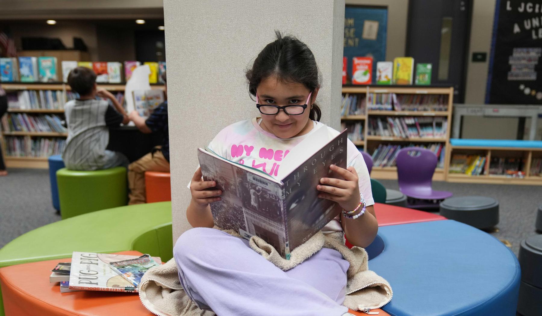 elementary school girl reading a book