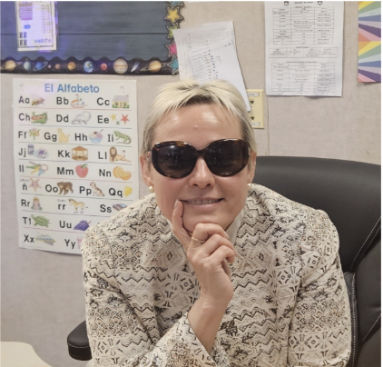 Picture of Principal Vardoumian with sunglasses in her office
