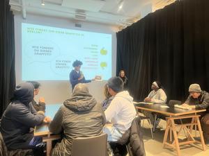 Group discussion about graffiti with a presentation and engaged audience.