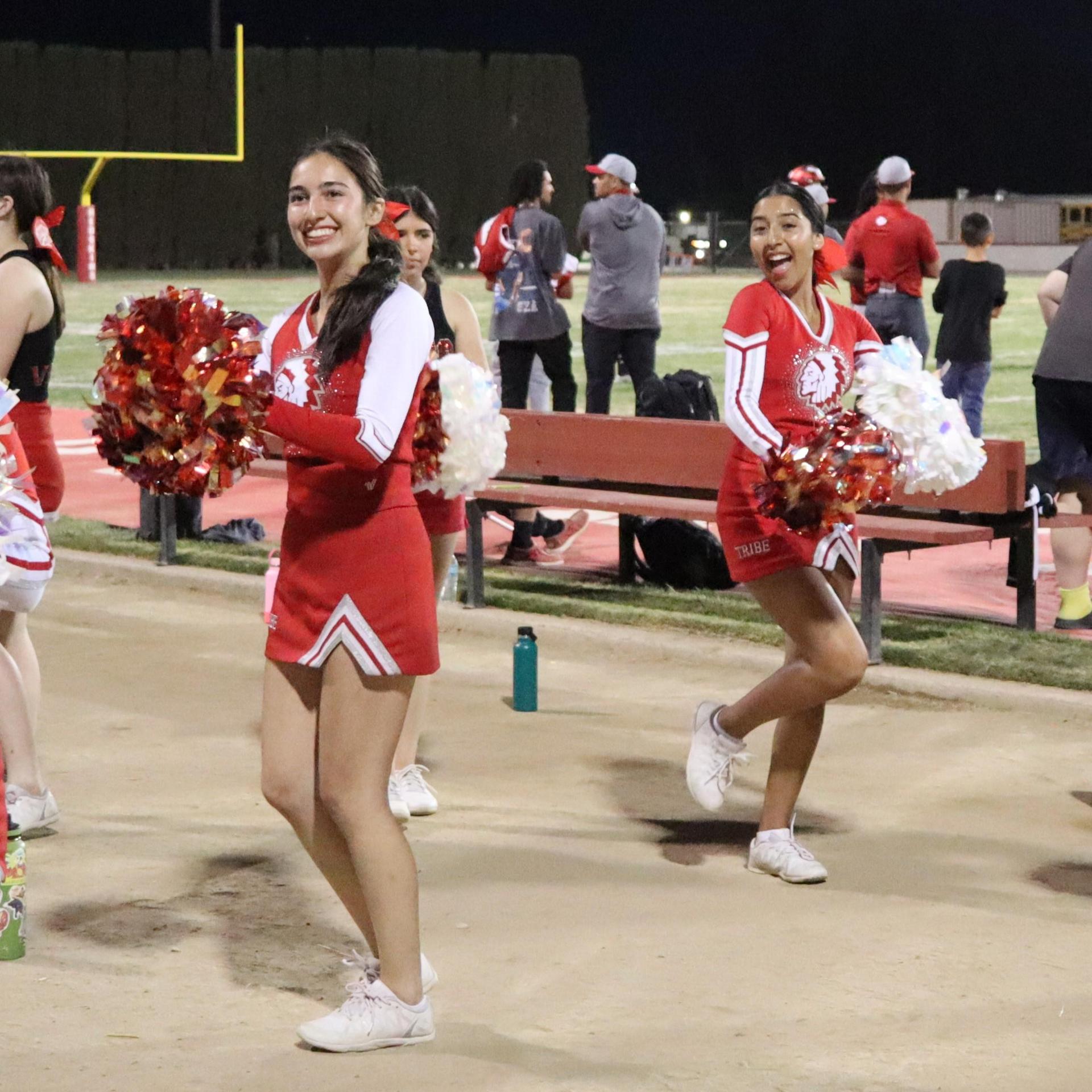 varsity cheerleaders in action at the Riverdale game