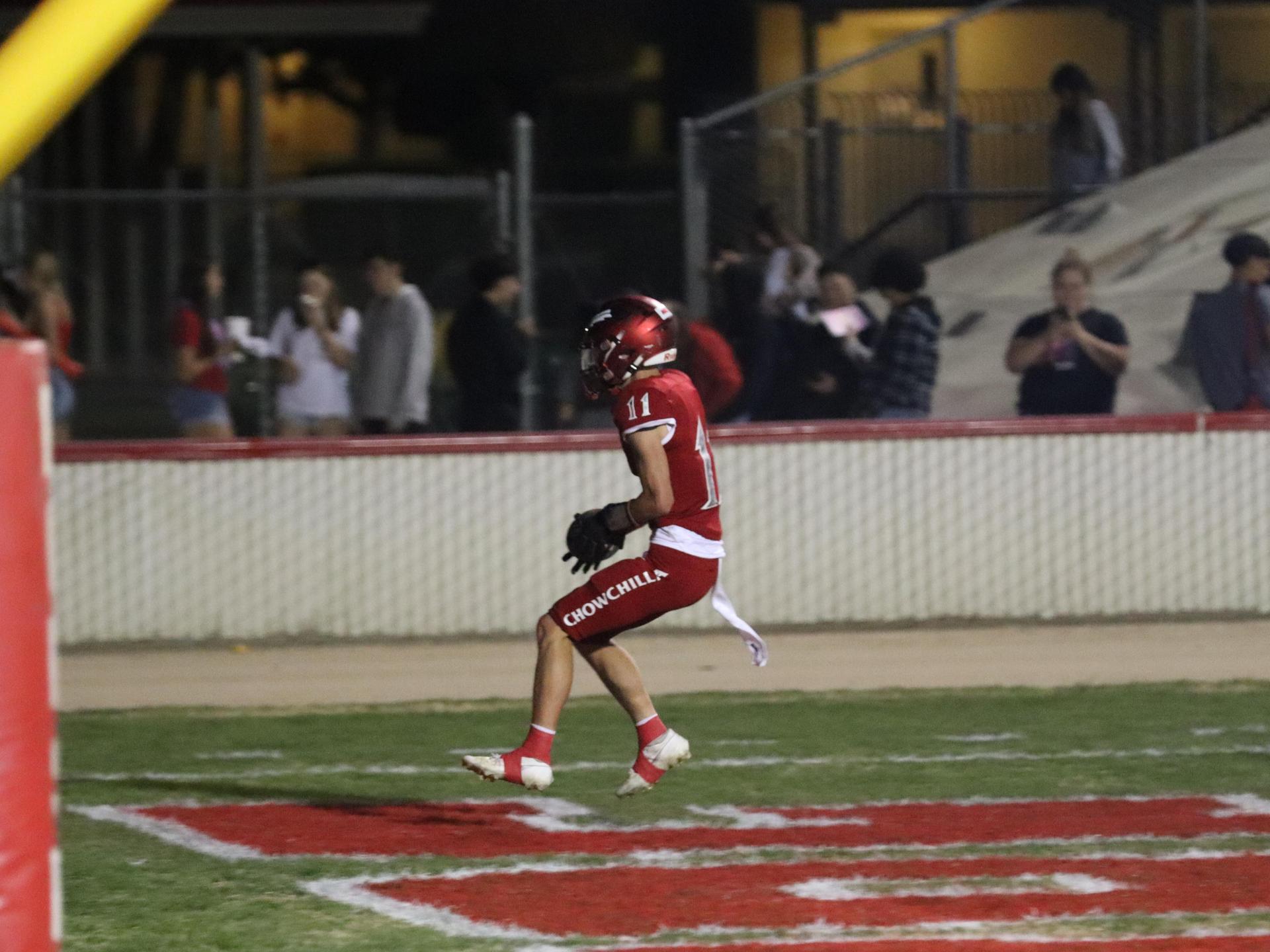varsity football players in action against Riverdale