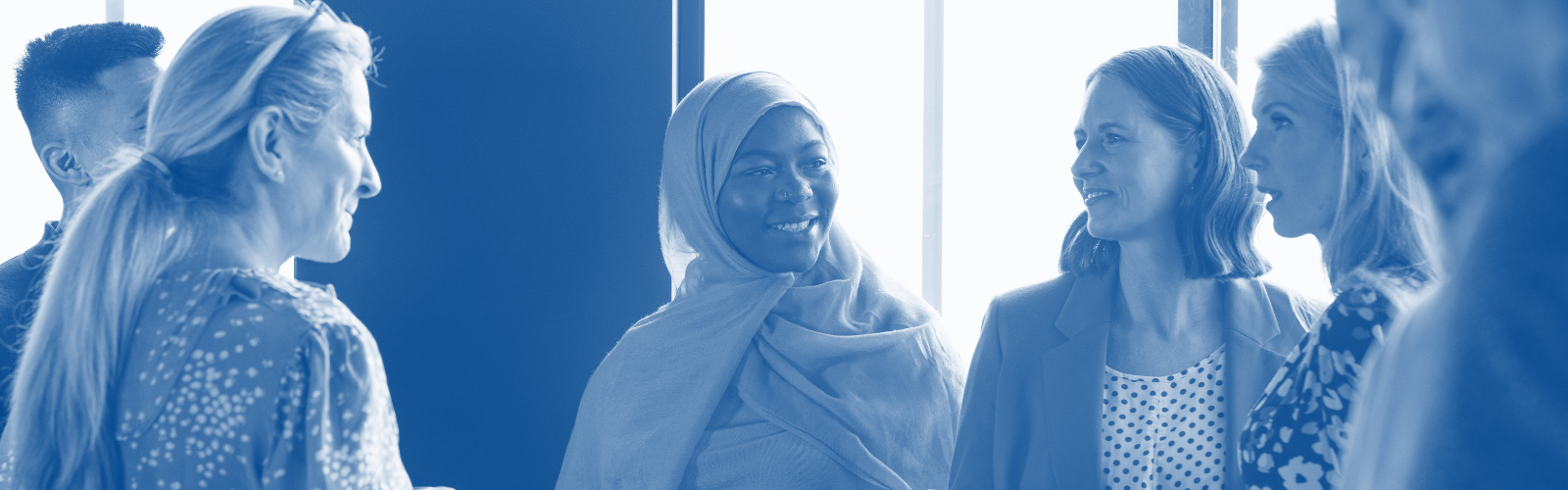 A diverse array of adults talk.