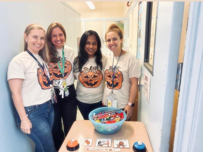 4 staff wearing pumpkin shirts