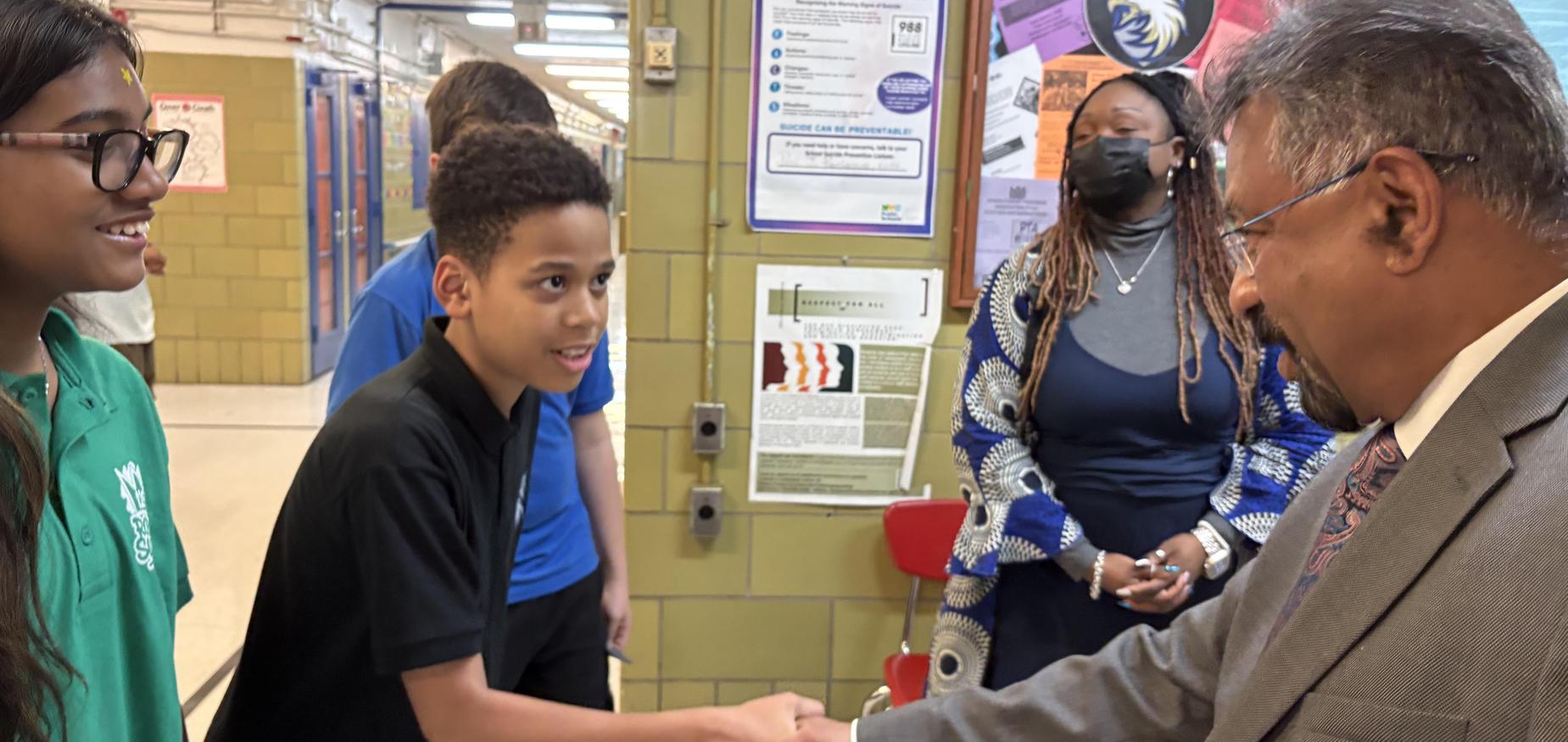 Student shaking hands with UN Ambassador