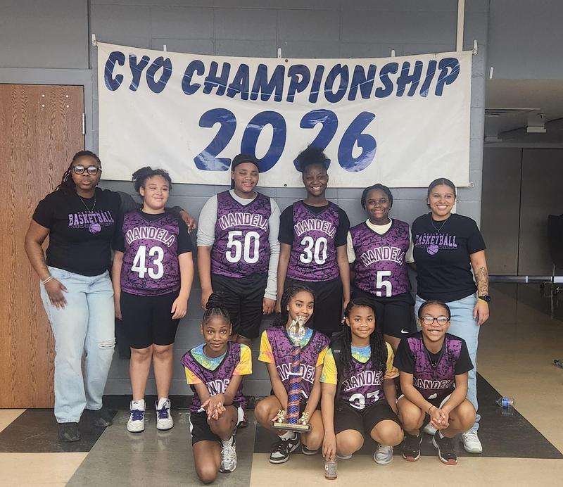Girls pose in front of CYO Championship 2026 banner