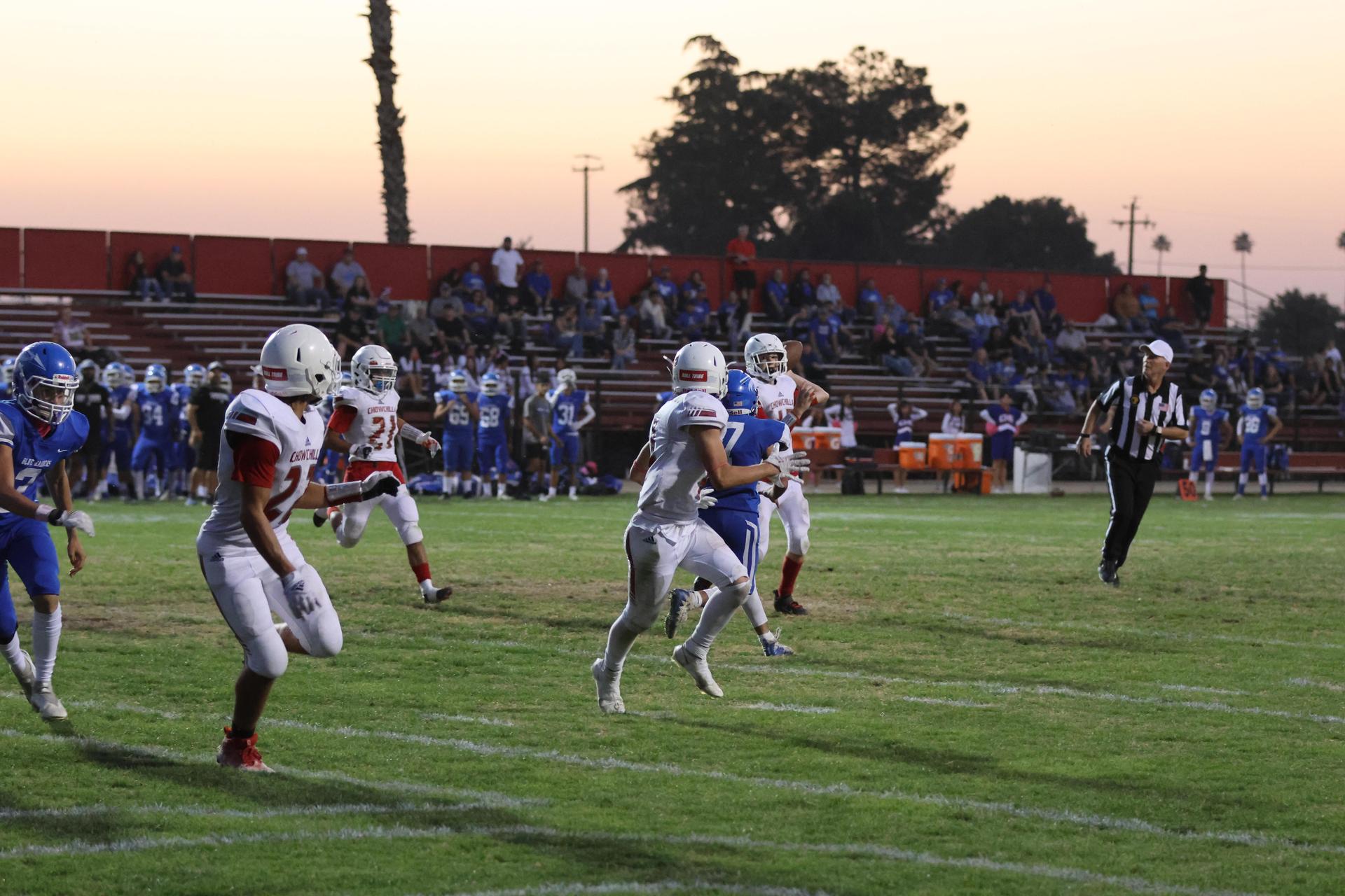 Junior Varsity football players in action against Caruthers