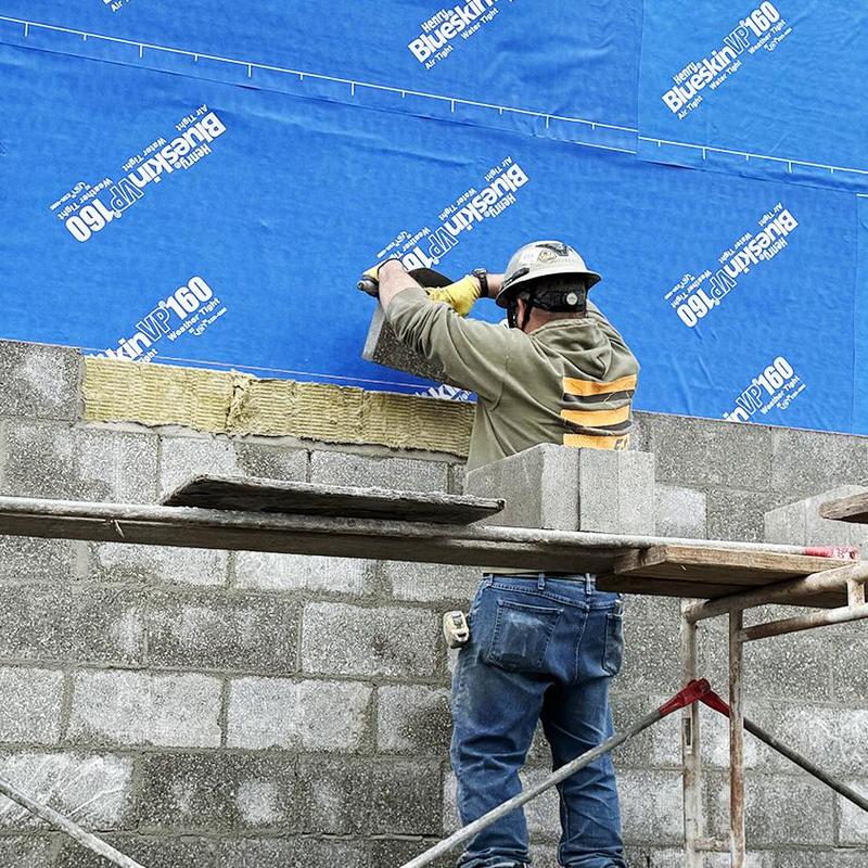 mason adds brick to building exterior