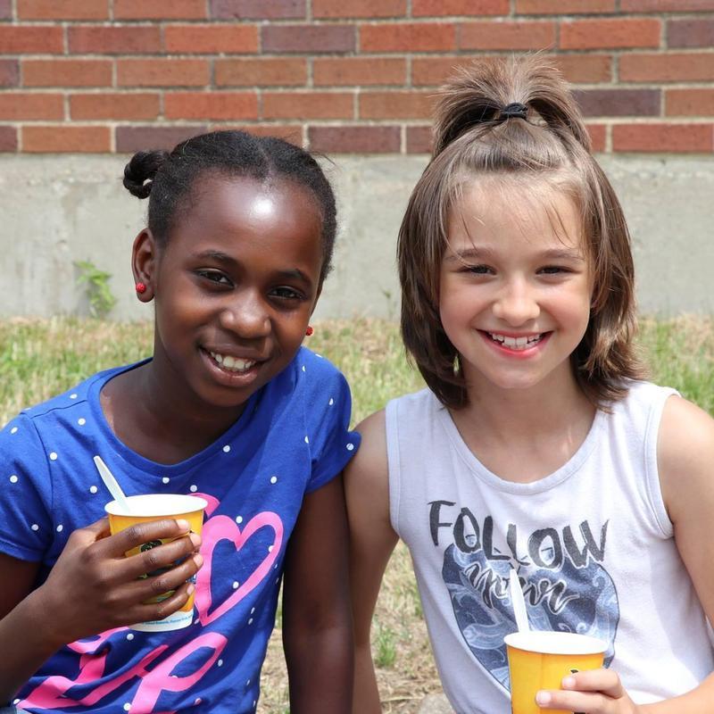 Two students sitting together and smiling