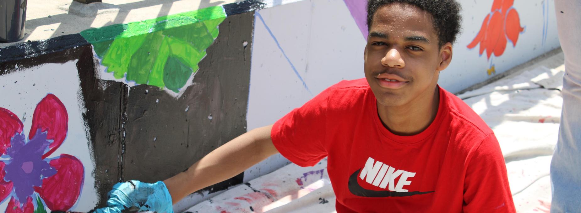 student painting mural