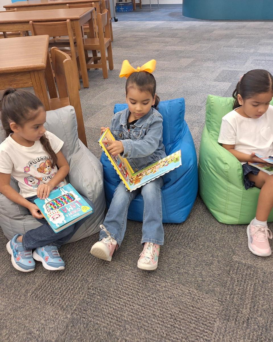 Kindergarten students enjoying free reading time.