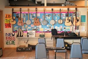 guitars and banjos hanging on a wall in the music classroom of HCIS tuition-free charter school