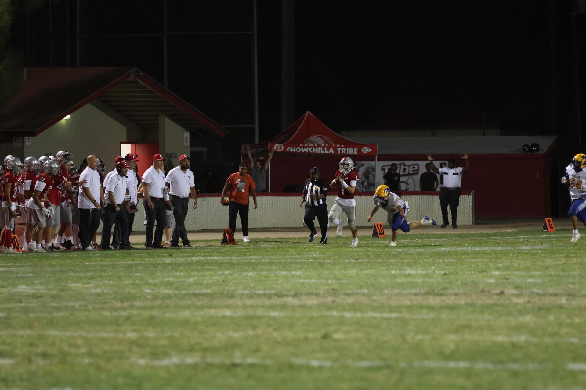 Varsity football players in action against Parlier 45