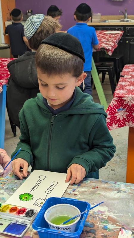 First grade boys work on watercolor vases