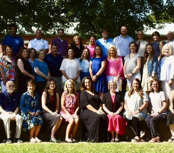 group of teachers smiling, posing for photo